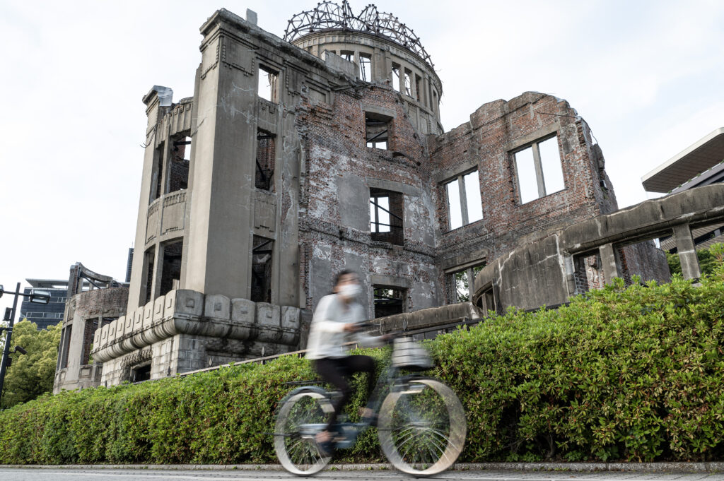 A cyclist rides past the Atomic Bomb Dome in Hiroshima on May 14, 2023, just days ahead of the arrival of leaders for the G7 Leaders' Summit. (AFP)