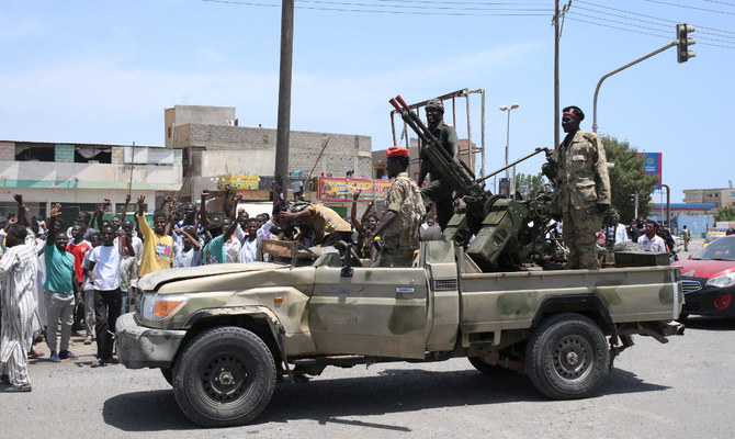 Sudanese greet army soldiers loyal to army chief Abdel Fattah Al-Burhan, in the Red Sea city of Port Sudan. (AFP)