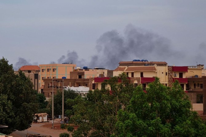 Smoke billows over residential buildings in Khartoum on April 30, 2023 as deadly clashes between rival generals’ forces entered their third week. (AFP)