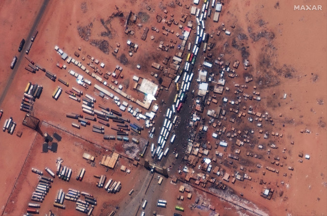 This handout satellite photograph taken on April 28, 2023v, and released by Maxar Technologies, shows a major crossing point at the Sudanese border of Argeen with Egypt, as buses wait in line to evacuate passengers into Egypt. (AFP)