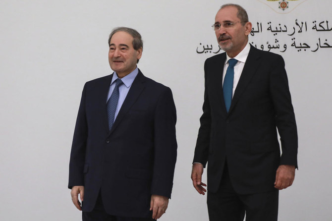Jordan’s Foreign Minister Ayman Safadi, right, arrives with his Syrian counterpart Faisal Mekdad to attend a regional consultative meeting held in Amman, Jordan on Monday, May 1, 2023. (AP)