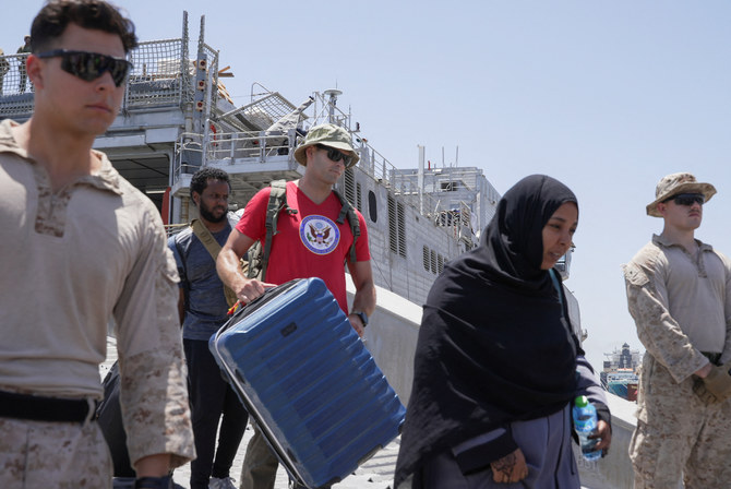 US citizens and other nationalities disembark from the US Navy fast transport ship, the USNS Brunswick, which arrived in Saudi Arabia from Sudan on May 1, 2023. (Reuters)