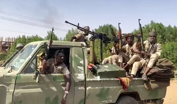 In this image grab taken from handout video footage released by the Sudanese paramilitary Rapid Support Forces (RSF) on April 23, 2023, fighters ride in the back of a technical vehicle in the East Nile district of greater Khartoum. (AFP)