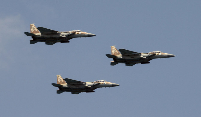 Israeli F-15 fighter jets perform during an air show over the beach in the Israeli coastal city of Tel Aviv on May 5, 2022. (AFP)