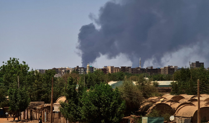 Smoke billows over buildings in Khartoum on May 1, 2023 as deadly clashes between rival generals' forces have entered their third week. (AFP)