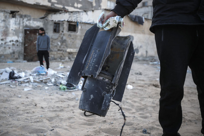 Residents inspect the area of an airstrike in Deir Al-Balah in the central Gaza Strip on May 3, 2023, following a flare-up between the Israeli military and Gaza militants. (AFP)