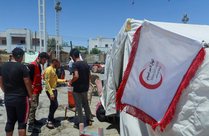 The Sundanese Red Crescent tent is seen next to people from Syria and Yemen nationalities as they wait for medical attention at a camp center to be processed for evacuation, following the crisis in Sudan’s capital Khartoum, in Port Sudan on May 4, 2023. (Reuters)