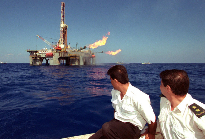 Palestinian navy officers look at the drilling operation launched 27 September 2000 to tap a newly-discovered gas field, which is due to start commercial production around the end of 2002, off the coast of Gaza. (AFP)