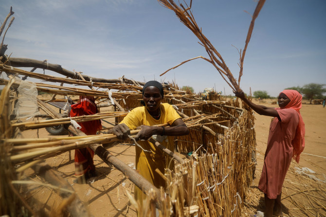 Sudanese refugee women, who fled the violence in their country build makeshift shelters while waiting to be placed in refugees camp near the border between Sudan and Chad in Koufroun, Chad, on May 6, 2023. (REUTERS/Zohra Bensemra)