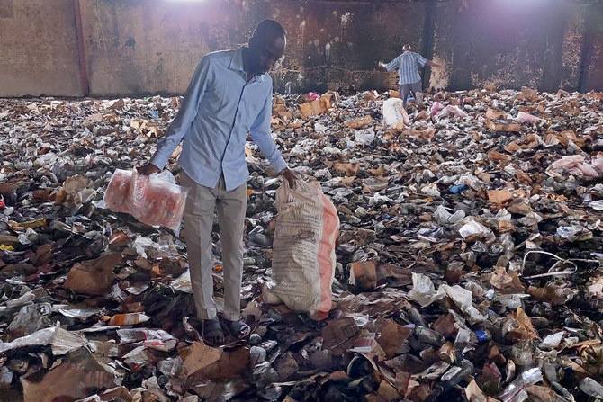 People salvage items from a medical storage destroyed amid fighting in Nyala, the capital of Sudan's province of South Darfur on May 2, 2023. (AFP)