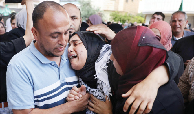 Relatives mourn during Sunday’s funeral of Diyar Omari, who was killed by an Israeli settler in a village north of Jenin. (AFP)