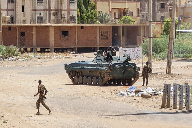 Sudanese Army soldiers walk near tanks stationed on a street in southern Khartoum on May 6, 2023, amid ongoing fighting against the paramilitary Rapid Support Forces. (AFP)