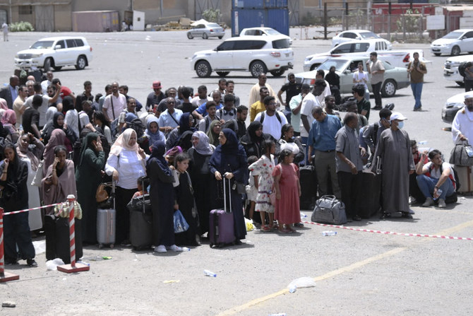People fleeing war-torn Sudan queue to board a boat at Port Sudan on April 28, 2023. (AFP)