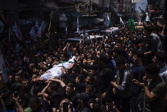 Mourners carry the bodies of Palestinians who were killed in Israeli airstrikes, during their funeral in Gaza City, Tuesday, May 9, 2023. (AP)
