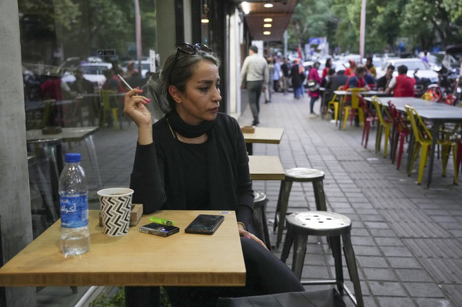 Above, a woman without wearing a mandatory Islamic headscarf in northern Tehran. More women are choosing not to wear the hijab publicly in Iran in open defiance of authorities. (AP)