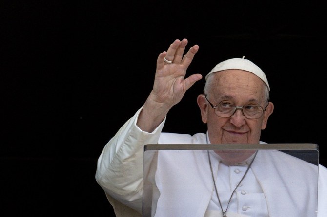 Pope Francis waves as he leads Regina Caeli prayer from his window at the Vatican. (Reuters)