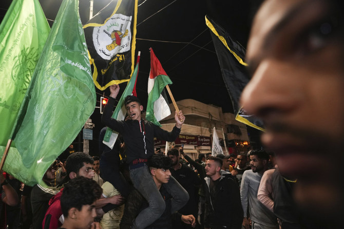 Palestinians celebrate the announcement of a cease-fire after five days of fighting between Israel and the Islamic Jihad militant group in Gaza City on May 13, 2023. (AP)