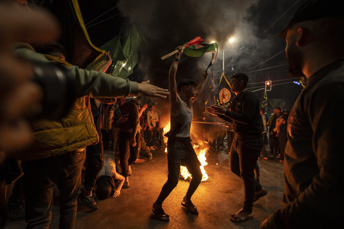 Palestinians celebrate the announcement of a cease-fire after five days of fighting between Israel and the Islamic Jihad militant group in Gaza City on May 13, 2023. (AP)