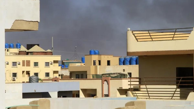 Smoke rises behind buildings in Khartoum amid ongoing fighting between the forces of two rival generals, on May 16, 2023. (AFP)