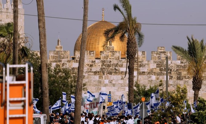 Israelis wave national flags in front of Damascus Gate outside Jerusalem’s Old City to mark Jerusalem Day, an Israeli holiday celebrating the capture of the Old City, May 29, 2022. (AP Photo)