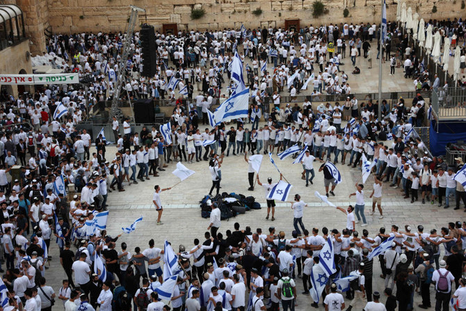 Israelis wave national flags as they gather at the Western Wall in the Old City of Jerusalem during the Israeli 'flags march' to mark