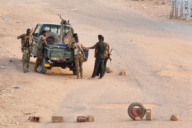 Soldiers of the Sudanese army stand man a checkpoint in Khartoum on May 20, 2023, as violence between two rival generals continues. (AFP)