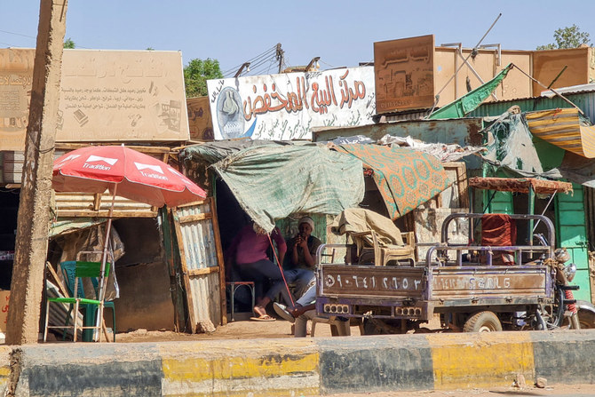 Vendors sit in a stall selling discounted goods in southern Khartoum on May 21, 2023, amid ongoing fighting between two rival generals. (AFP)