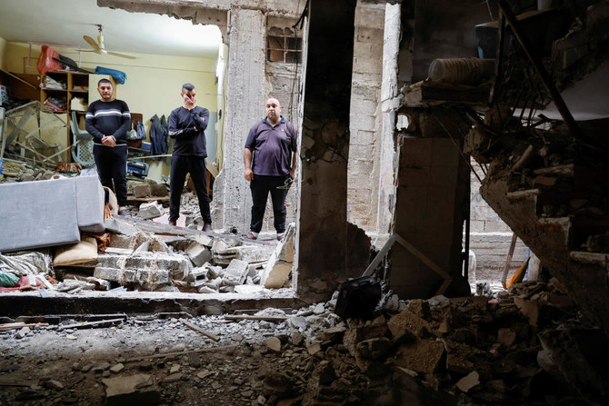 Palestinians check a house damaged during an Israeli raid, in Balata camp, Nablus, in the Israeli-occupied West Bank. (Reuters)