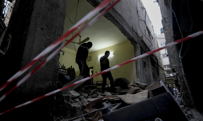 Palestinians inspect a damaged building following an Israeli army raid in the Balata refugee camp near the West Bank town of Nablus, May 22, 2023. (AP)