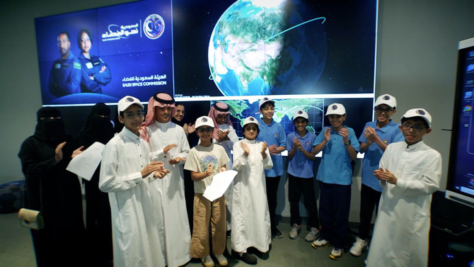 The two Saudi astronauts make radio contact with a group of Saudi students during the passage of the International Space Station over a ground station in Riyadh. (Twitter: @saudispace)