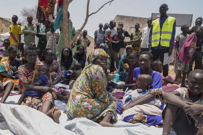South Sudanese who fled from Sudan sit outside a nutrition clinic at a transit center in Renk, South Sudan. (AP)