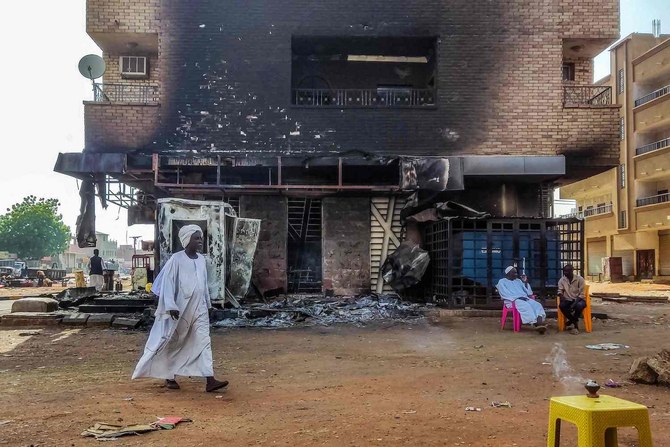 A man walks past a burnt out bank branch in southern Khartoum on May 24, 2023. (AFP)