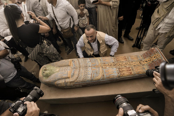 Mostafa Waziri, secretary-general of the Supreme Council of Antiquities, displays a recently unearthed ancient wooden sarcophagus at the site of the Step Pyramid of Djoser in Saqqara, 24 kilometers southwest of Cairo on May 27, 2023. (AP)