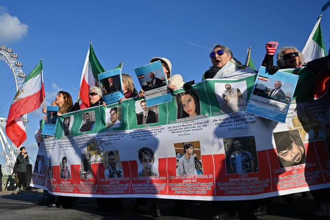 Protesters hold placards at a march in central London on January 21, 2023 against the Islamic revolutionary Guard Corps (IRGC), as protests against the Iranian regime (AFP)