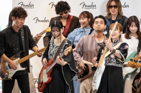 Popular Japanese musicians play their guitars during a press conference a day ahead of the opening of the first global flagship store by US guitar maker Fender, in Tokyo on June 29, 2023. (AFP)