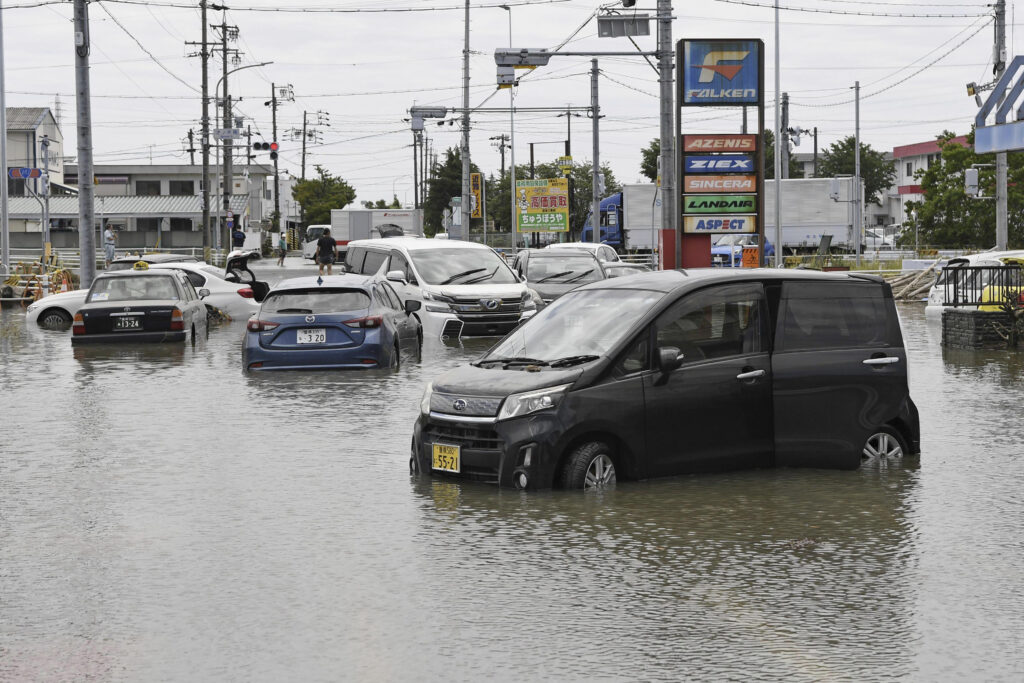 Cars are submerged on a flooded road due to strong rain in Toyokawa, Aichi prefecture, central Japan Saturday, June 3, 2023. (File/Kyodo News via AP)