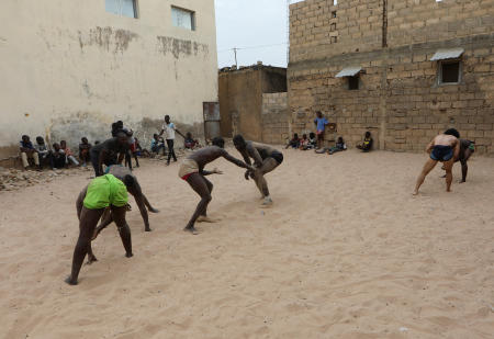 Wrestlers train within the arena of the Samba Dia stable in the Diakhao neighbourhood, in Thies, Senegal, May 26, 2023. (Reuters)