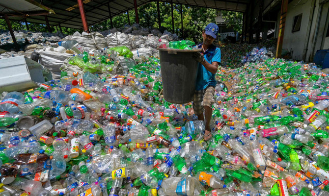 A worker sorts plastic bottles at a recycling facility in Panagoda, Sri Lanka. (AFP)