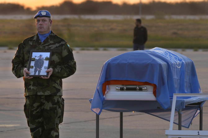 Above, an Irish UN peacekeeper stands next to the coffin of his comrade Private Sean Rooney, who was killed on Dec. 15, 2022 in the first fatal attack on UN peacekeepers in Lebanon since 2015. (AP)