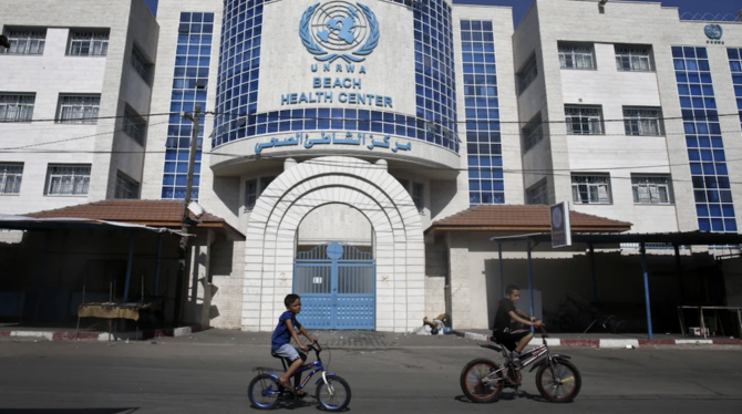 Children ride their bicycles in front of a health center run by the United Nations Relief and Works Agency in Gaza on October 2, 2018. (AFP/File Photo)