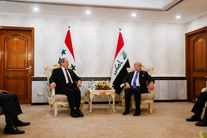Syrian Foreign Minister Faisal Mekdad speaks with his Iraqi counterpart Fuad Hussein in Baghdad, Iraq June 4, 2023. (Reuters)