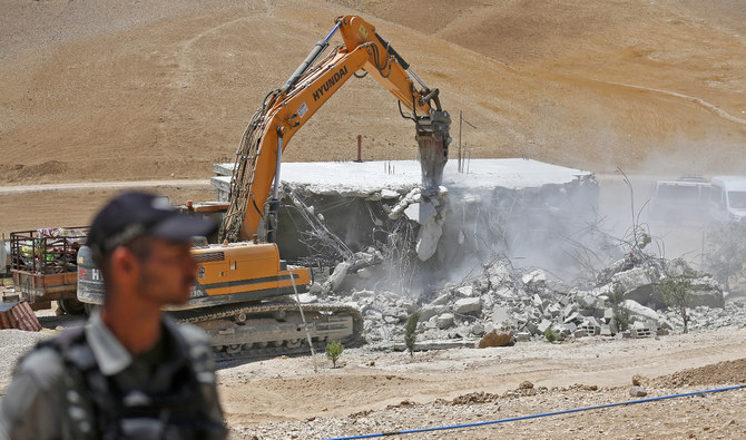 An Israeli bulldozer demolishes a Palestinian house in the Umm Qasas area of Masafer Yatta in the occupied West Bank on July 25, 2022. (AFP/File)