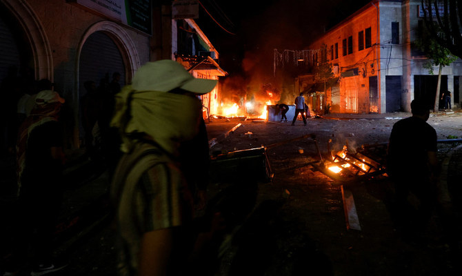 Palestinians demonstrate as the Israeli army raids Ramallah, in the Israeli-occupied West Bank, June 8, 2023. (Reuters)