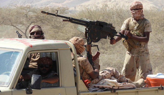 Yemeni fighters loyal to the government ride in the back of a pickup truck with mounted heavy machine gun in the Mesini Valley in the vast province of Hadramawt. (AFP file photo)