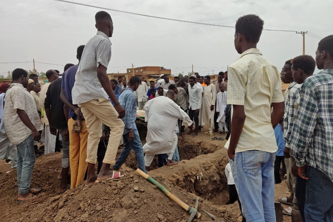 Mourners gather to bury the victims killed by an artillery shell strike in southern Khartoum on June 11, 2023. (AFP)