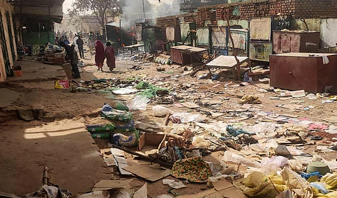 People walk among scattered objects in the market of El-Geneina, the capital of West Darfur, as fighting continues in Sudan between the forces of two rival generals, on April 29, 2023. (AFP/File)