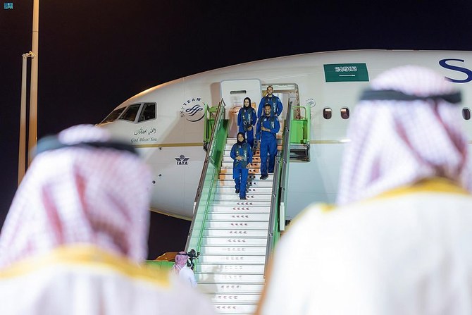 Above, the Saudi astronauts are welcomed home at King Khaled International Airport. (SPA)