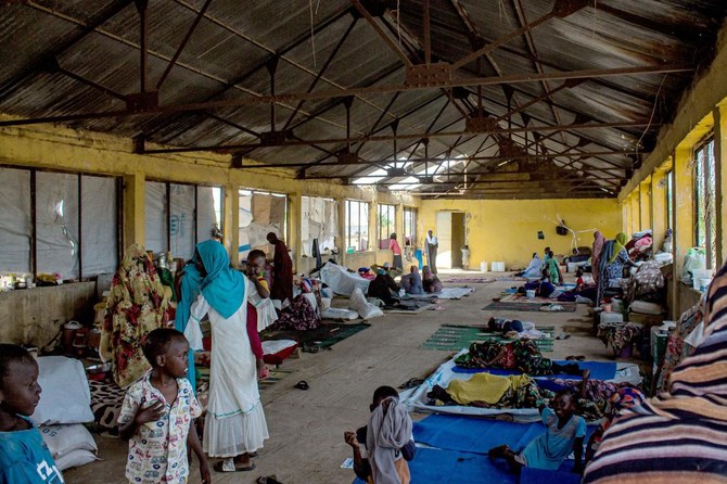 Women and children gather in a building at a camp for the internally displaced in Al-Suwar, about 15 kilometers north of Wad Madani, on June 22, 2023. (AFP)