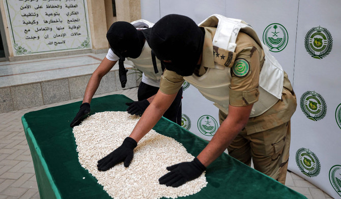 In this file photo taken on March 1, 2022, Officers of the Directorate of Narcotics Control of Saudi Arabia's Interior Ministry sort through tablets of captagon (Fenethylline) seized during a special operation in the Red Sea coastal city of Jeddah. (AFP)