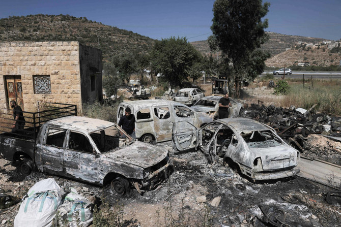 A picture shows burnt cars, reportedly set ablaze by Israeli settlers, in the area of in al-Lubban al-Sharqiya in the occupied West Bank on June 21, 2023. (AFP)